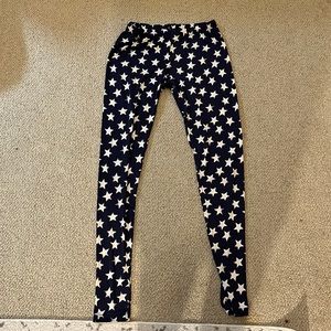 White stars on navy leggings. Medium